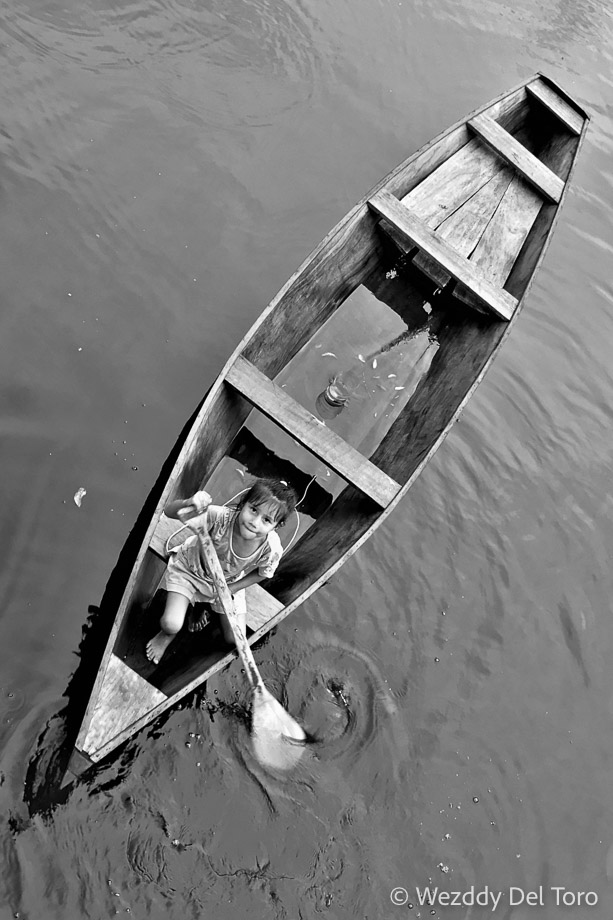 “My paddle, my toy.” A girl from one of the local communities in her canoe.