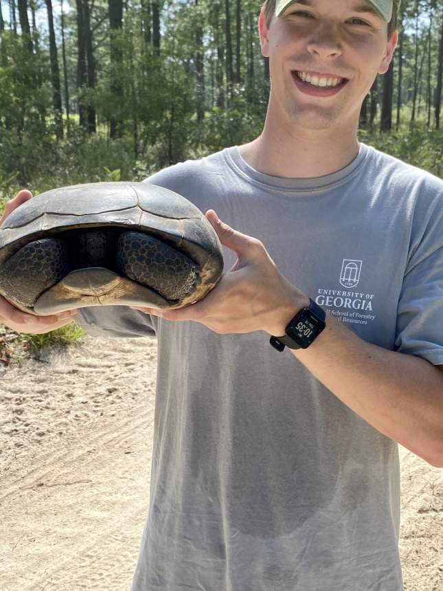 Seth Lattner holds a turtle