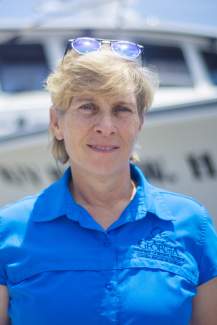 Carolyn Belcher stands on a dock