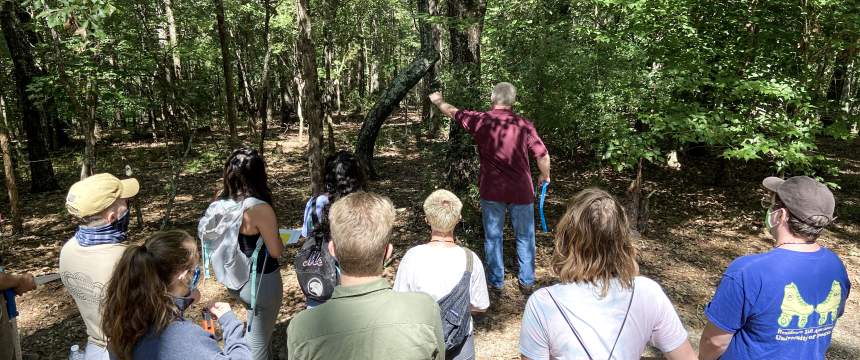 Pete Bettinger teaches a class in the woods