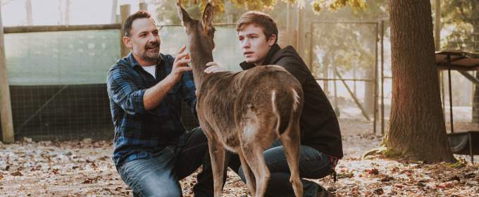 Wildlife sciences professor Gino D’Angelo examines a healthy deer with undergraduate student Jack Buban at the University of Georgia Deer Research Facility. (Photo by David Choe)